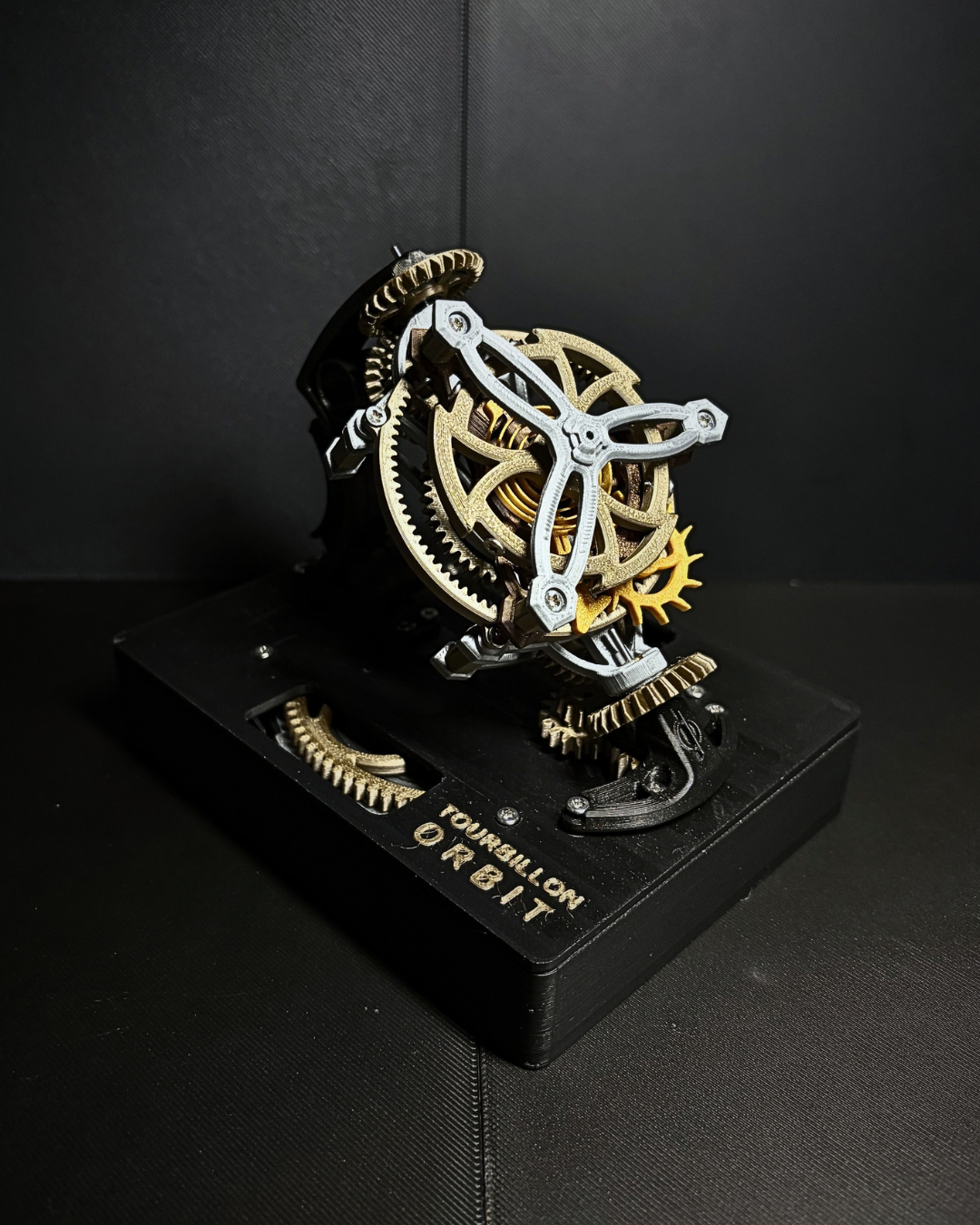 Palm-sized Mechanica tourbillon desk object with exposed gold and silver mechanism