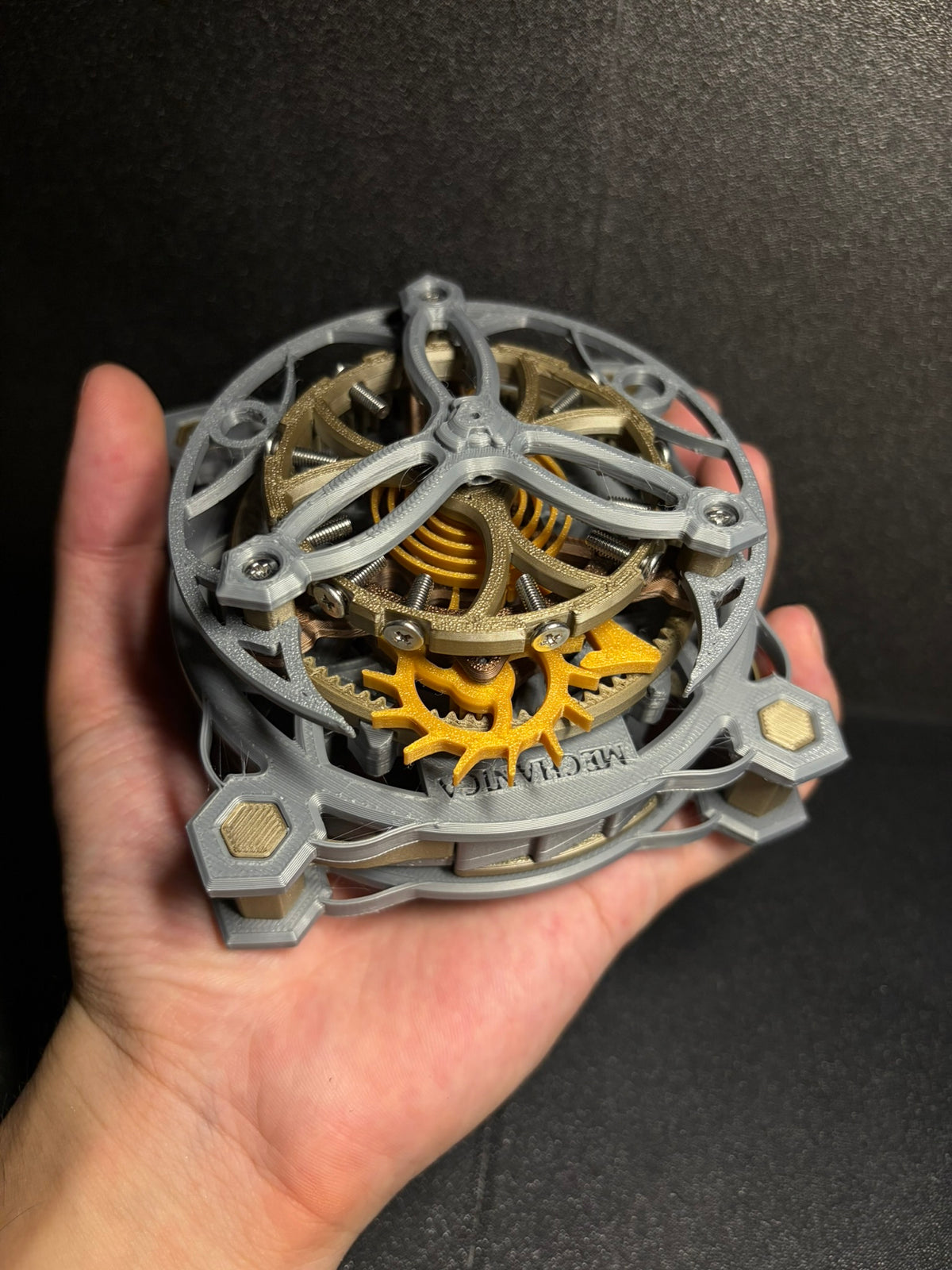 An open mechanism showing the visible spring and rotating cage